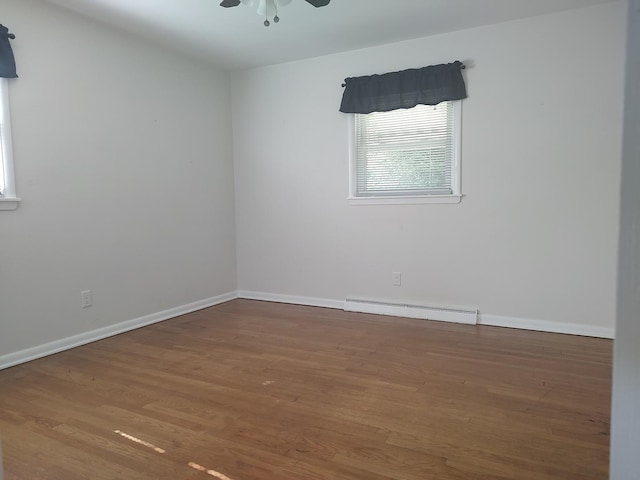 406 Highland St, Belvidere, IL 61008 - spare room with baseboard heating, ceiling fan, and wood finished floors
