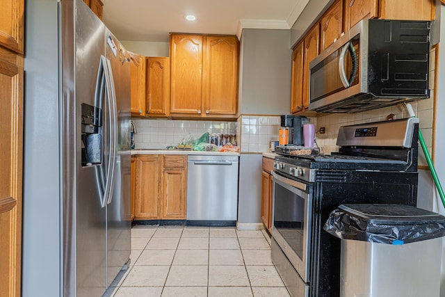635 Robin Ct, Grayslake, IL 60030 - kitchen with stainless steel appliances, light countertops, decorative backsplash, light tile patterned floors, and brown cabinets