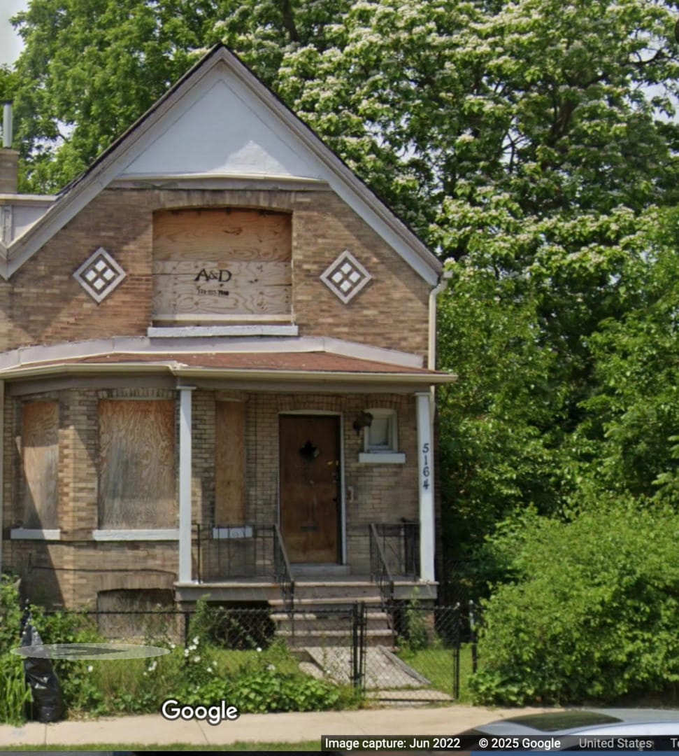 5164 S Wabash Ave, Chicago, IL 60615 - view of front of home with brick siding, covered porch, and a fenced front yard