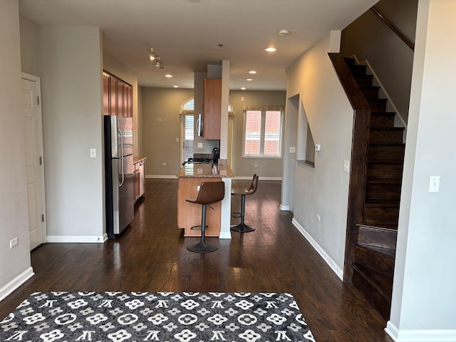 331 E 17th St, Chicago, IL 60616 - kitchen with stainless steel appliances, dark wood-style flooring, a kitchen bar, a peninsula, and recessed lighting