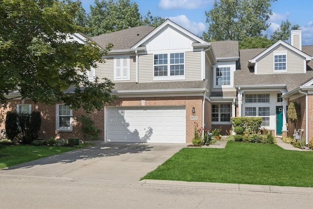 2566 Camberley Cir, Westchester, IL 60154 - view of front of property with a garage, driveway, brick siding, a front lawn, and roof with shingles