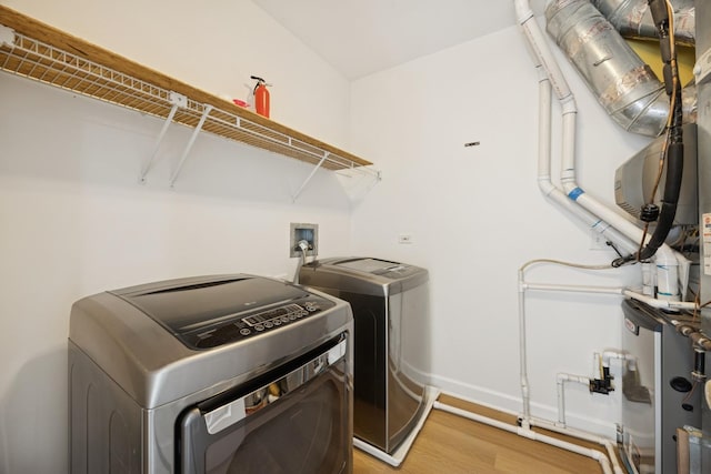 2566 Camberley Cir, Westchester, IL 60154 - laundry area featuring washer and clothes dryer and light wood-type flooring