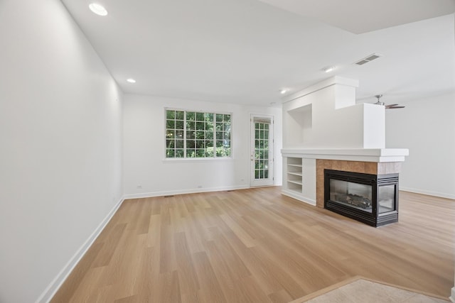 2566 Camberley Cir, Westchester, IL 60154 - unfurnished living room featuring light wood finished floors, a tile fireplace, and recessed lighting