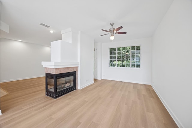 2566 Camberley Cir, Westchester, IL 60154 - unfurnished living room with ceiling fan, a fireplace, light wood-type flooring, and recessed lighting