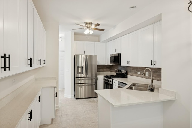 2566 Camberley Cir, Westchester, IL 60154 - kitchen featuring appliances with stainless steel finishes, decorative backsplash, a ceiling fan, and white cabinets