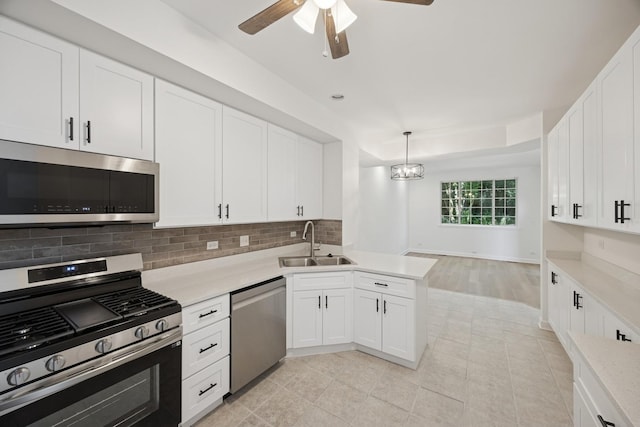 2566 Camberley Cir, Westchester, IL 60154 - kitchen with stainless steel appliances, light countertops, backsplash, ceiling fan, and white cabinets
