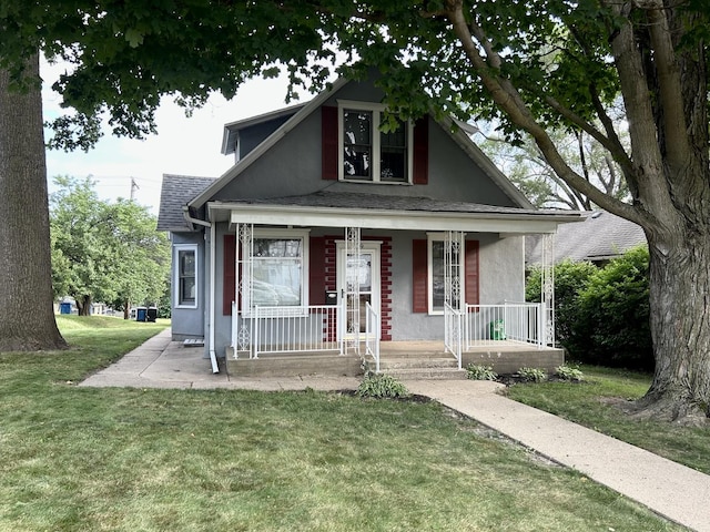 109 E Minnesota St, Spring Valley, IL 61362 - bungalow-style home featuring covered porch, stucco siding, a front yard, and a shingled roof