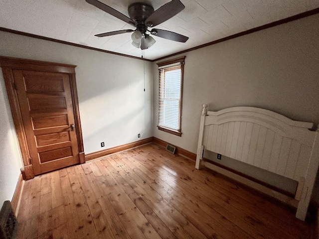 109 E Minnesota St, Spring Valley, IL 61362 - unfurnished bedroom with crown molding, light wood-style flooring, and a ceiling fan