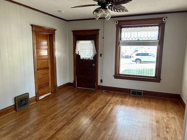 109 E Minnesota St, Spring Valley, IL 61362 - foyer entrance featuring hardwood / wood-style flooring, ornamental molding, ceiling fan, and wood walls