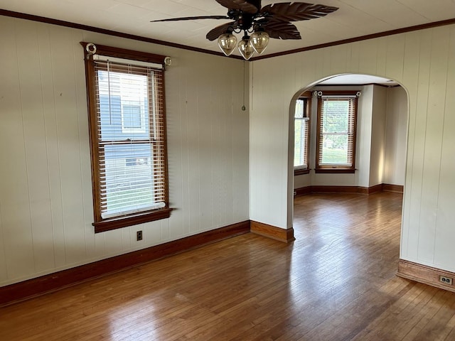 109 E Minnesota St, Spring Valley, IL 61362 - spare room with arched walkways, ornamental molding, hardwood / wood-style flooring, healthy amount of natural light, and ceiling fan