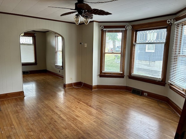 109 E Minnesota St, Spring Valley, IL 61362 - unfurnished room featuring ornamental molding, arched walkways, light wood-type flooring, and a ceiling fan