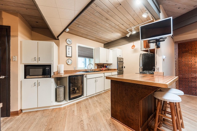 817 Meadow Ln, Sycamore, IL 60178 - kitchen with beverage cooler, butcher block countertops, light wood-style flooring, and wooden ceiling