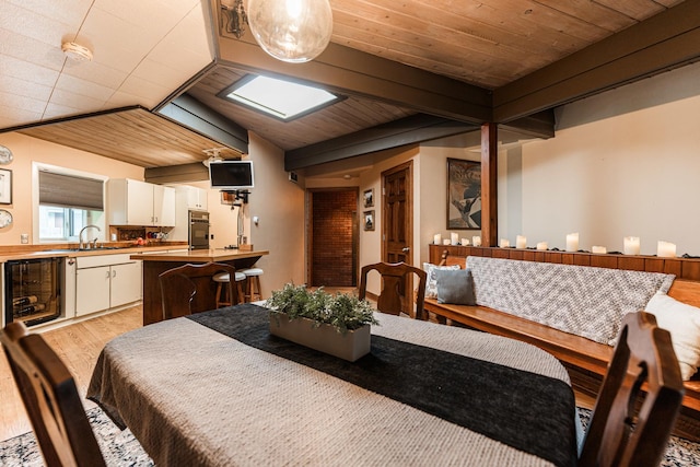 817 Meadow Ln, Sycamore, IL 60178 - dining room with light wood-style floors, wine cooler, and a wood ceiling with exposed beams