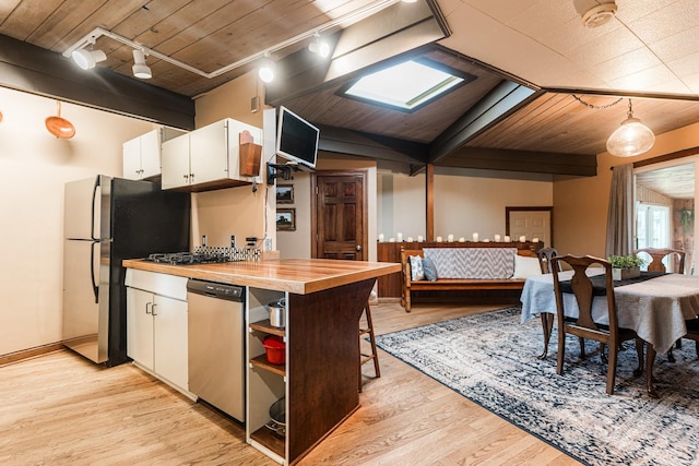 817 Meadow Ln, Sycamore, IL 60178 - kitchen with appliances with stainless steel finishes, white cabinets, a wooden ceiling with exposed beams, light wood finished floors, and butcher block counters