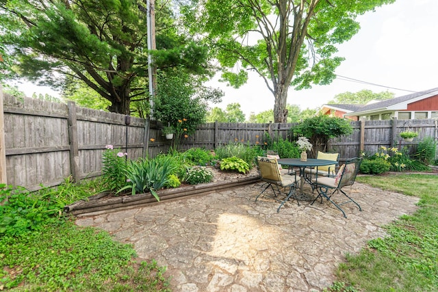 817 Meadow Ln, Sycamore, IL 60178 - fenced backyard featuring a patio area and outdoor dining area