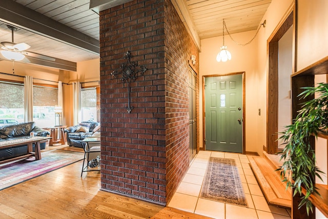 817 Meadow Ln, Sycamore, IL 60178 - entryway featuring wood ceiling, brick wall, a ceiling fan, and wood finished floors
