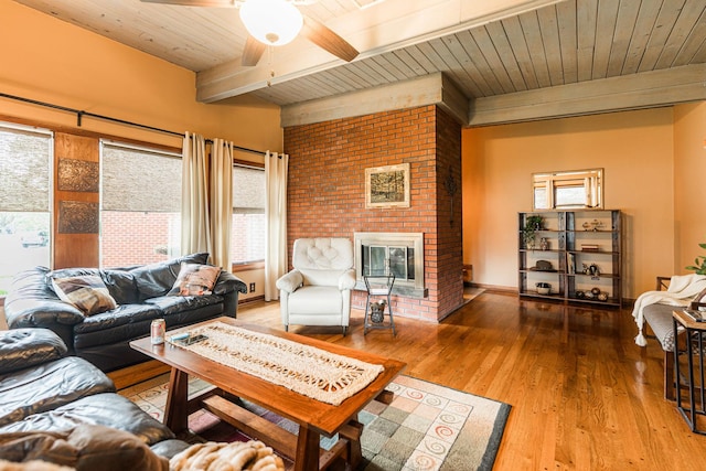 817 Meadow Ln, Sycamore, IL 60178 - living area featuring a wood ceiling with exposed beams, healthy amount of natural light, a fireplace, a ceiling fan, and wood finished floors