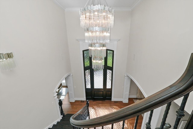6403 S Garfield Ave, Burr Ridge, IL 60527 - foyer entrance with a chandelier, a high ceiling, wood finished floors, stairs, and arched walkways