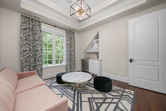 6403 S Garfield Ave, Burr Ridge, IL 60527 - sitting room featuring crown molding, a chandelier, bar with sink, a tray ceiling, and dark wood finished floors