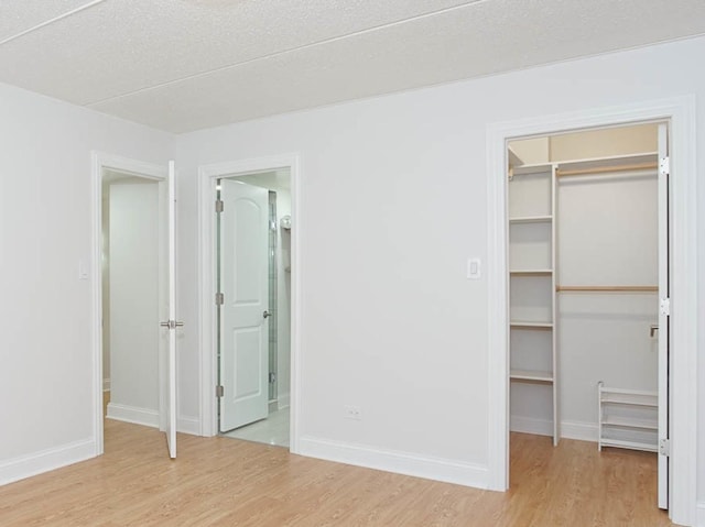 11104 O Gorman Dr Unit 41B, Palos Hills, IL 60465 - unfurnished bedroom featuring a spacious closet, light wood-style floors, a closet, and ensuite bathroom