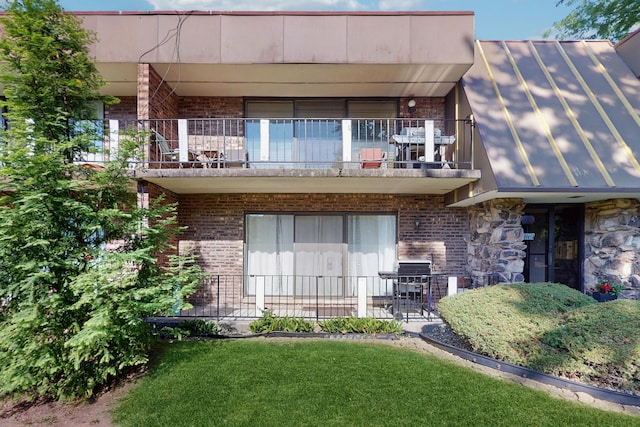 11104 O Gorman Dr Unit 41B, Palos Hills, IL 60465 - rear view of house featuring a balcony, a standing seam roof, brick siding, a yard, and a metal roof