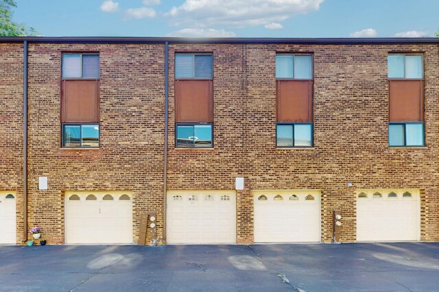 11104 O Gorman Dr Unit 41B, Palos Hills, IL 60465 - view of building exterior featuring a garage and driveway