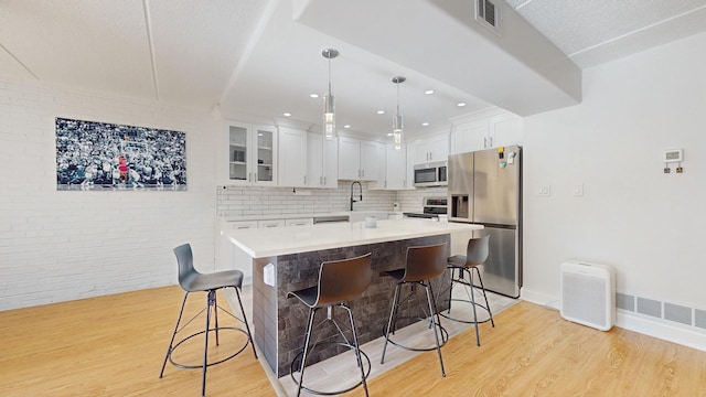 11104 O Gorman Dr Unit 41B, Palos Hills, IL 60465 - kitchen featuring appliances with stainless steel finishes, light wood-type flooring, a kitchen bar, and recessed lighting