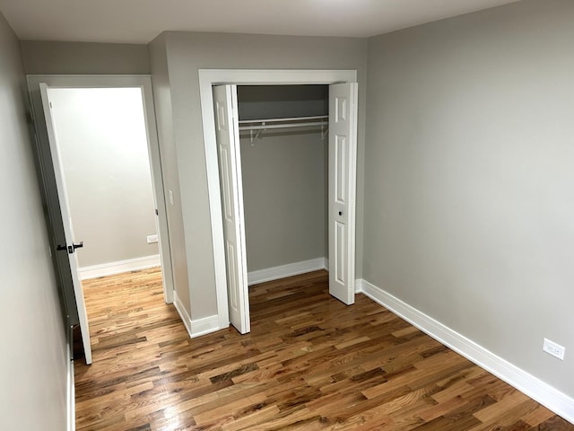 1224 S Harding Ave, Chicago, IL 60623 - unfurnished bedroom featuring wood finished floors and a closet