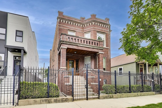 2333 N Spaulding Ave, Chicago, IL 60647 - multi unit property featuring brick siding, a fenced front yard, and a balcony