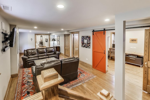 2333 N Spaulding Ave, Chicago, IL 60647 - living area featuring a barn door, light wood-style flooring, and recessed lighting