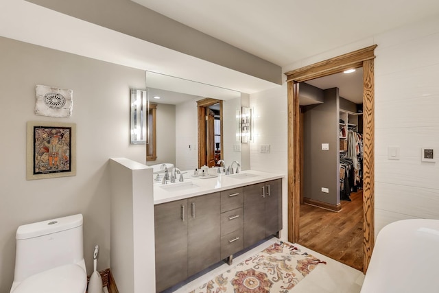 2333 N Spaulding Ave, Chicago, IL 60647 - bathroom with wood finished floors, double vanity, and a walk in closet