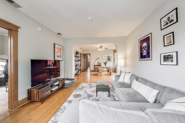 2333 N Spaulding Ave, Chicago, IL 60647 - living area with arched walkways, light wood-style flooring, and ceiling fan