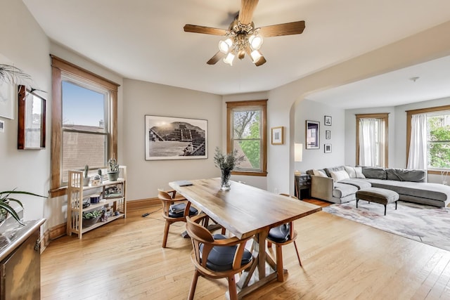 2333 N Spaulding Ave, Chicago, IL 60647 - dining area with light wood finished floors, a ceiling fan, and arched walkways