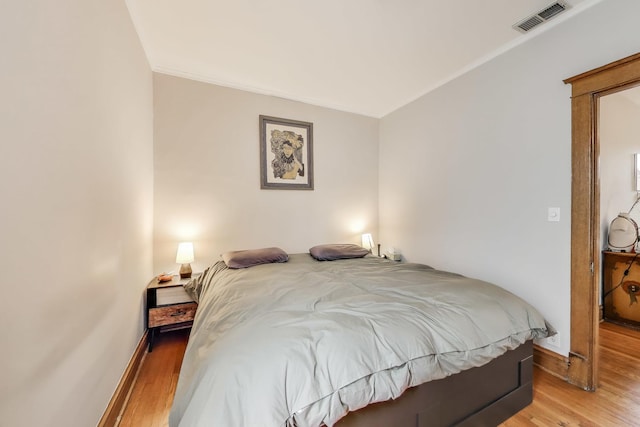 2333 N Spaulding Ave, Chicago, IL 60647 - bedroom with light wood-type flooring and crown molding