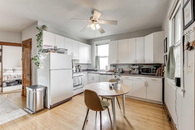2333 N Spaulding Ave, Chicago, IL 60647 - kitchen featuring white appliances, ceiling fan, light wood-type flooring, and white cabinets