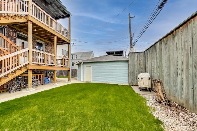 2333 N Spaulding Ave, Chicago, IL 60647 - view of green lawn featuring an outdoor structure, a wooden deck, a patio, and stairs