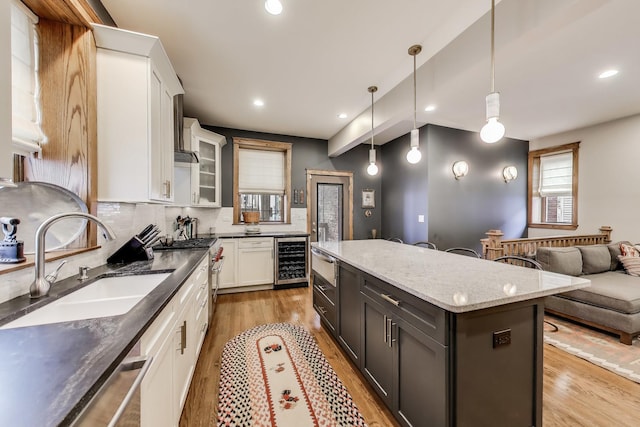 2333 N Spaulding Ave, Chicago, IL 60647 - kitchen featuring wine cooler, light wood finished floors, white cabinetry, healthy amount of natural light, and recessed lighting