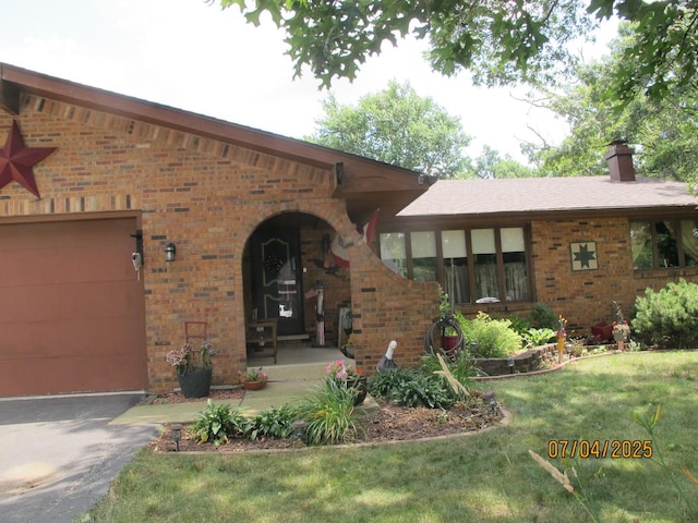 15521 116th Ct, Orland Park, IL 60467 - entrance to property featuring brick siding, a chimney, a garage, and a yard