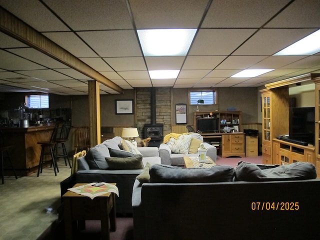 15521 116th Ct, Orland Park, IL 60467 - carpeted living room with a wood stove, a paneled ceiling, and plenty of natural light