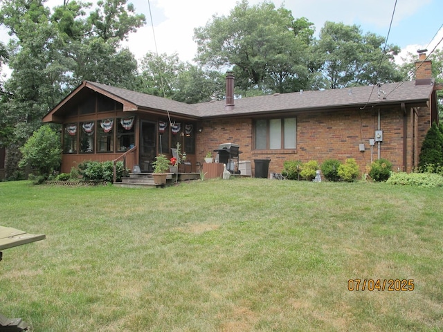 15521 116th Ct, Orland Park, IL 60467 - back of property with a yard, brick siding, a chimney, and a shingled roof