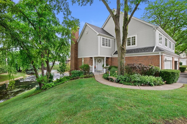 700 Monroe Dr, Lindenhurst, IL 60046 - view of front facade with brick siding, a front yard, an attached garage, and a shingled roof