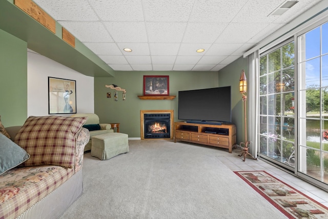 700 Monroe Dr, Lindenhurst, IL 60046 - carpeted living area featuring a paneled ceiling, a warm lit fireplace, and recessed lighting