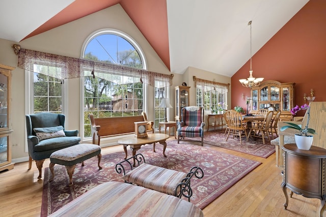 700 Monroe Dr, Lindenhurst, IL 60046 - living area featuring high vaulted ceiling, plenty of natural light, light wood finished floors, and a chandelier
