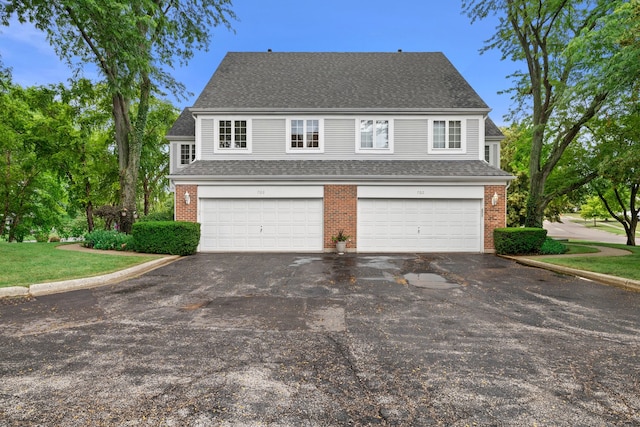 700 Monroe Dr, Lindenhurst, IL 60046 - view of front of property featuring asphalt driveway, an attached garage, brick siding, roof with shingles, and a front yard