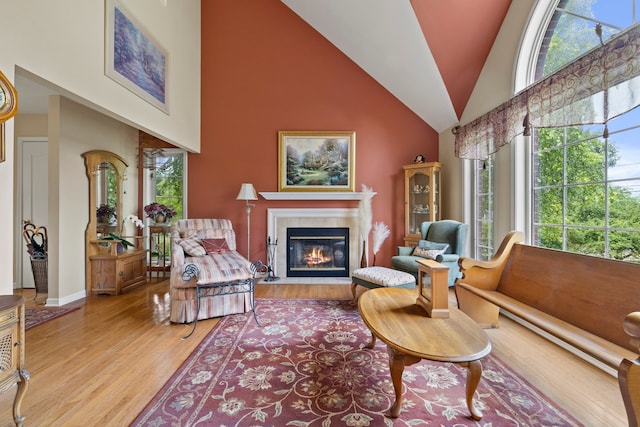 700 Monroe Dr, Lindenhurst, IL 60046 - living area with high vaulted ceiling, a tile fireplace, healthy amount of natural light, and light wood-style floors