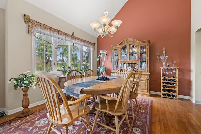 700 Monroe Dr, Lindenhurst, IL 60046 - dining space with light wood-type flooring, a chandelier, and high vaulted ceiling