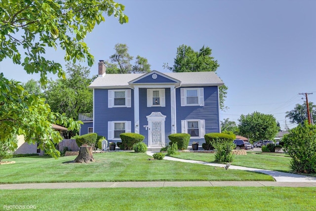 25 E 150th St, Harvey, IL 60426 - neoclassical / greek revival house featuring a chimney and a front lawn
