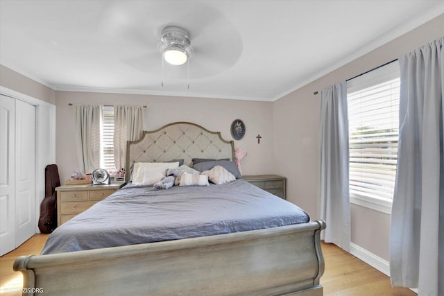 25 E 150th St, Harvey, IL 60426 - bedroom with multiple windows, light wood finished floors, ceiling fan, a closet, and ornamental molding