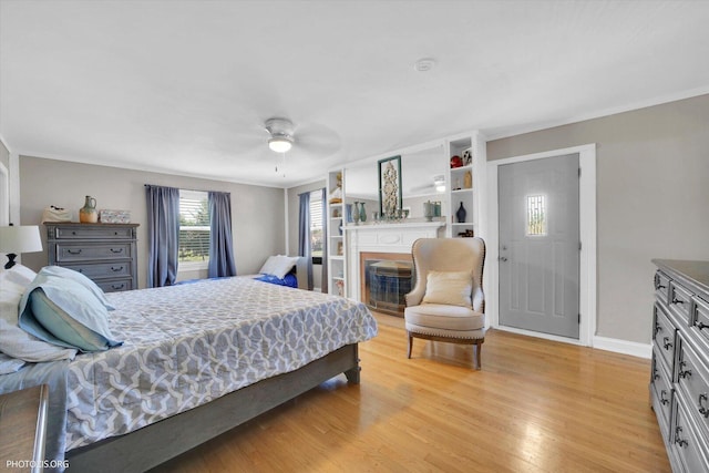 25 E 150th St, Harvey, IL 60426 - bedroom featuring light wood finished floors, a glass covered fireplace, and a ceiling fan