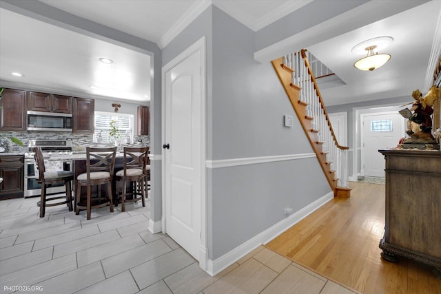 25 E 150th St, Harvey, IL 60426 - kitchen with stainless steel appliances, dark brown cabinets, a breakfast bar area, decorative backsplash, and light countertops